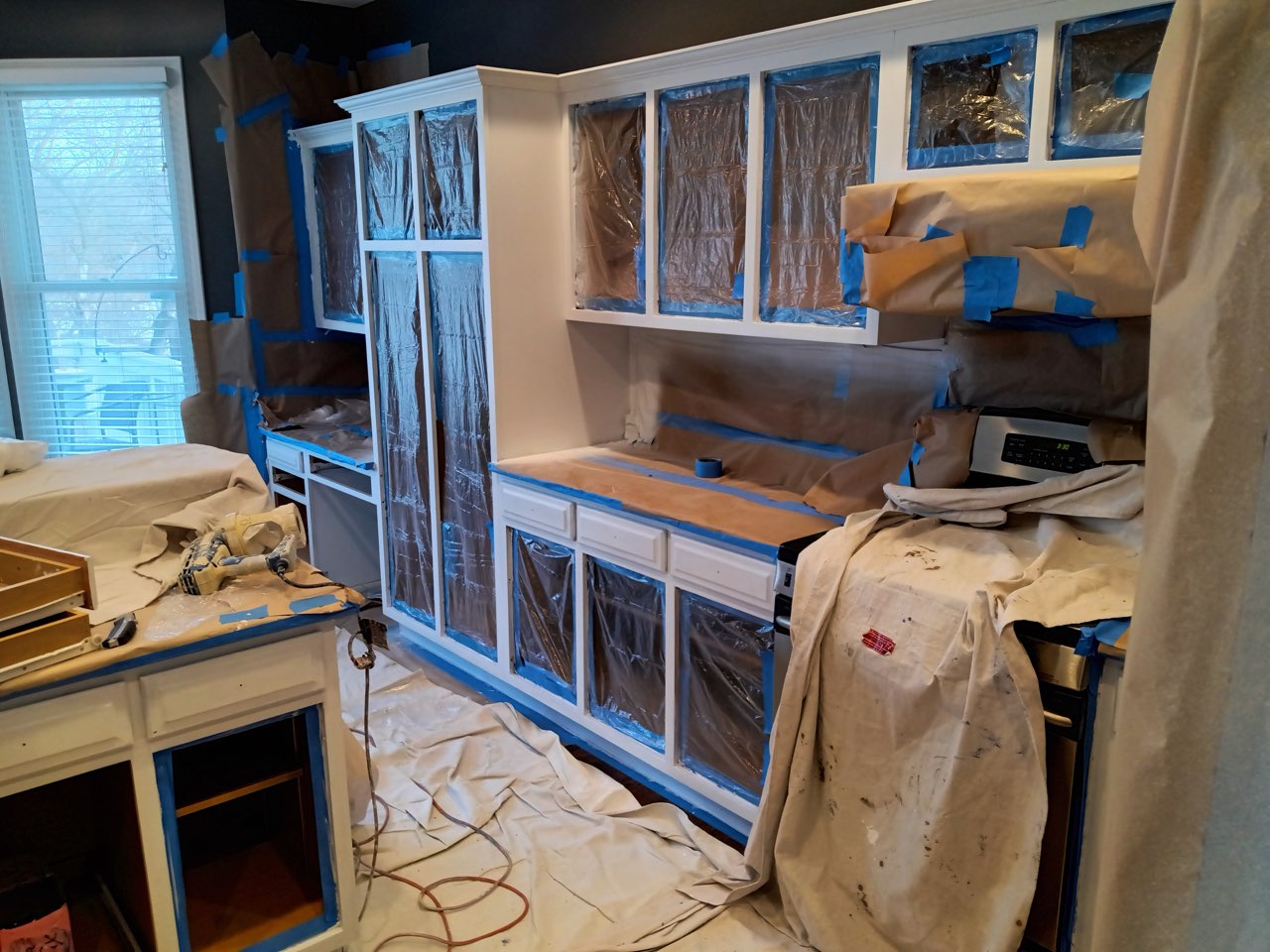 Kitchen cabinets masked and taped, ready for refinishing