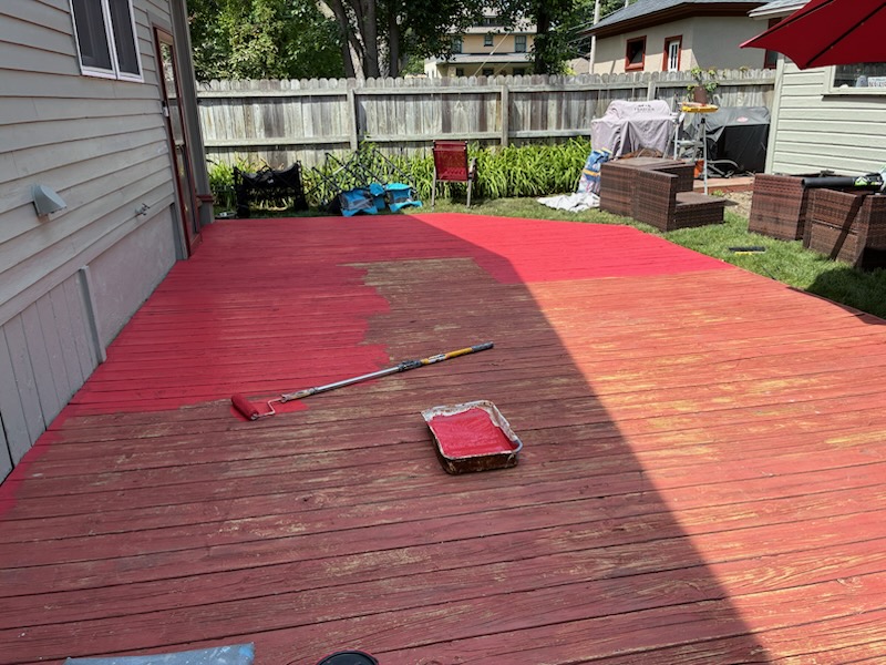 Weathered deck partway through staining